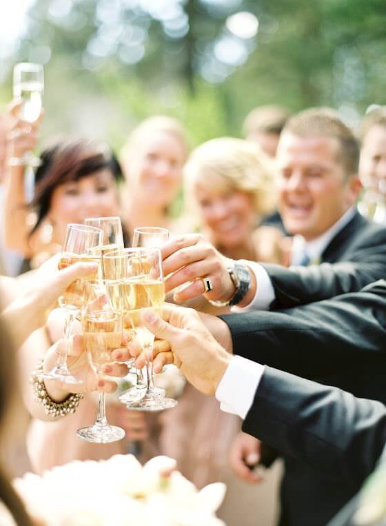 A bridal party toasting glasses of champagne.