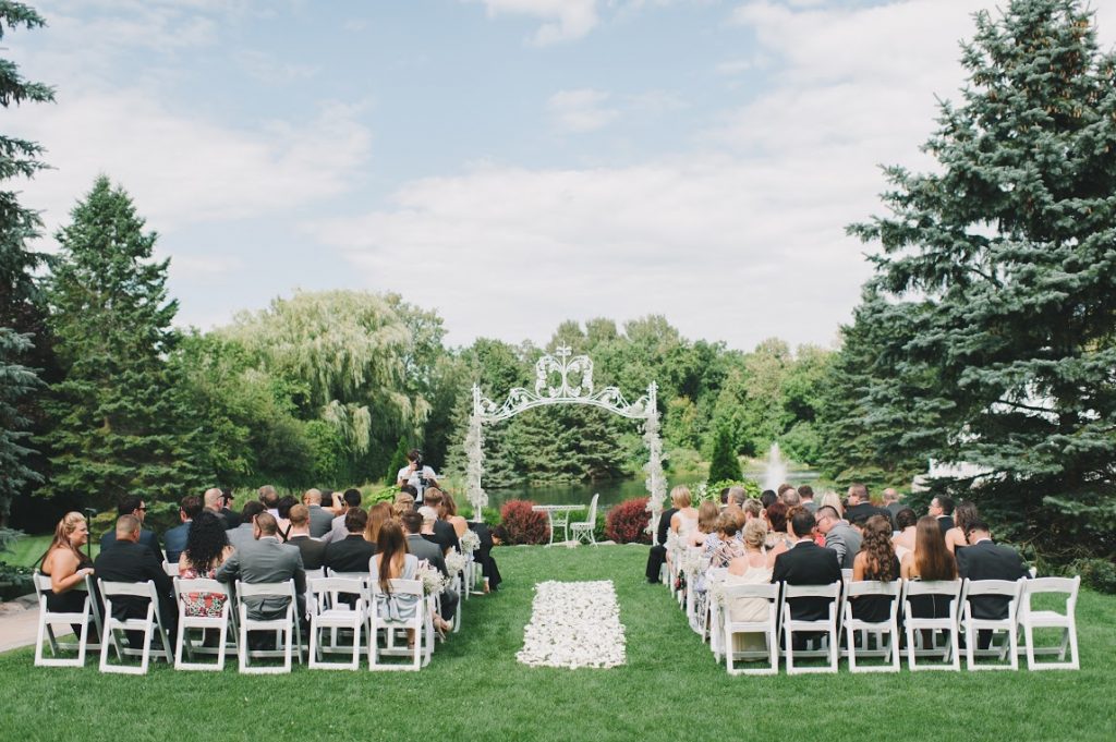 Garden wedding ceremony with guests.