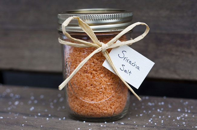 Glass mason jar with bowtie holding orange sriracha salt