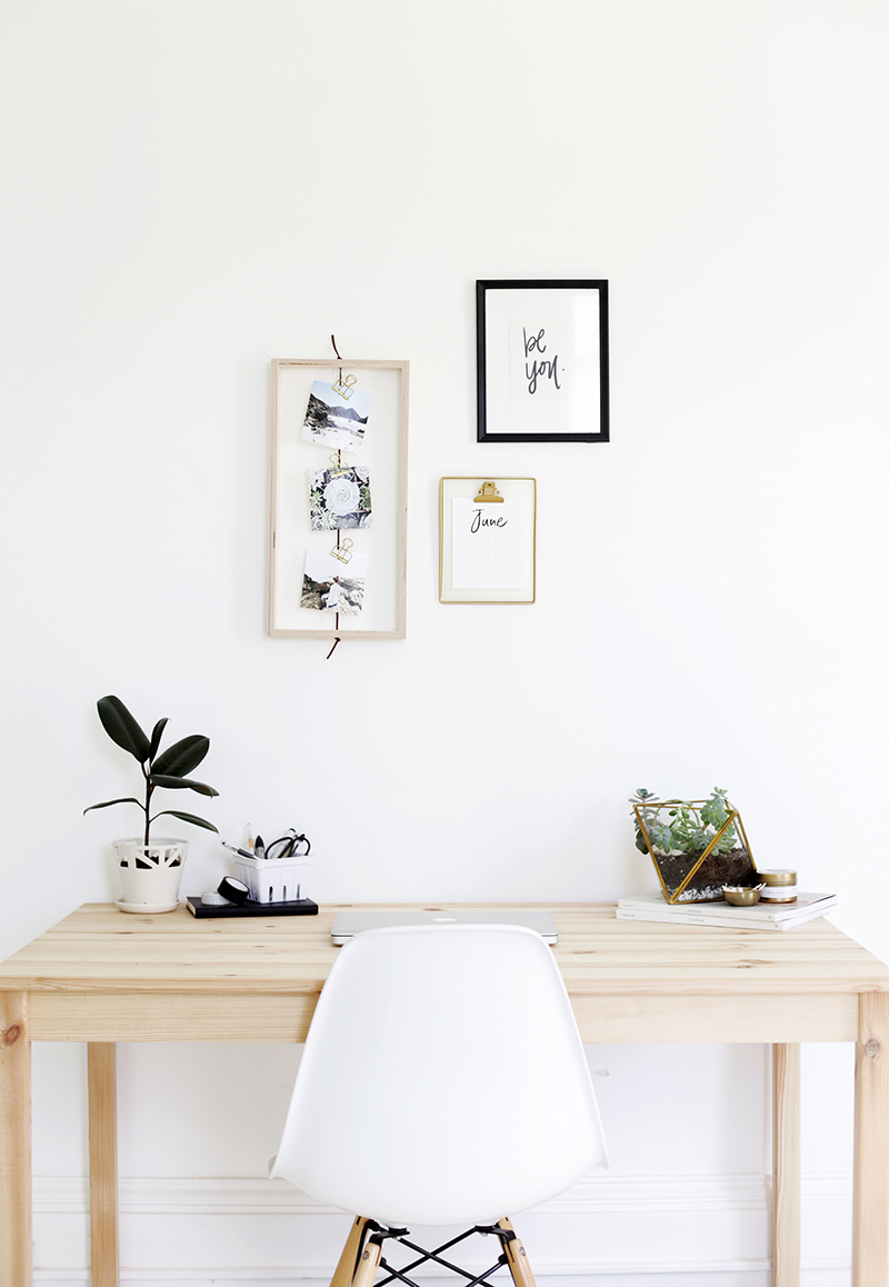 diy photo frame above desk space with plants