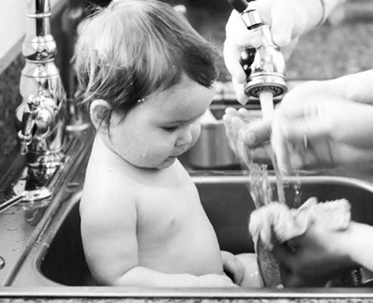 baby in kitchen sink
