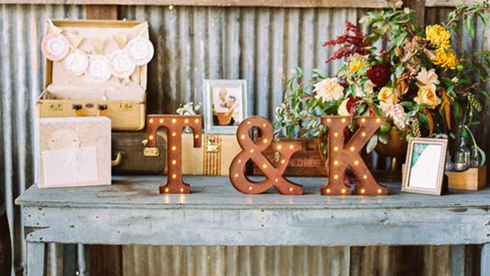 suitcase wedding card box on table arrangement with monogrammed marquee