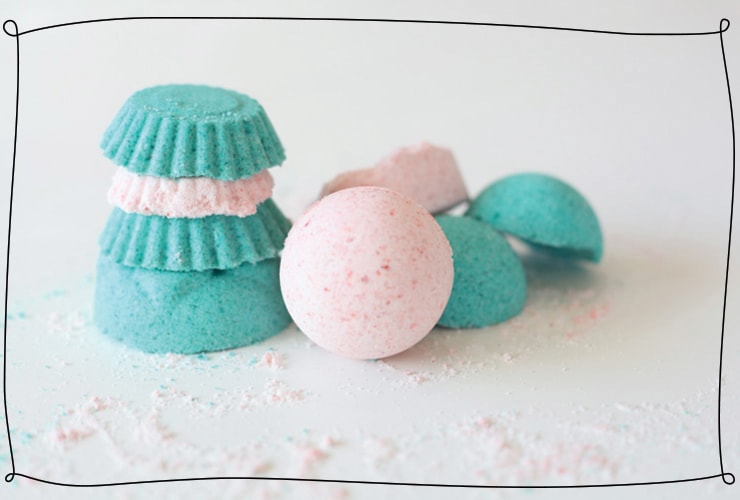 Bath bombs in pink and turquoise are stacked