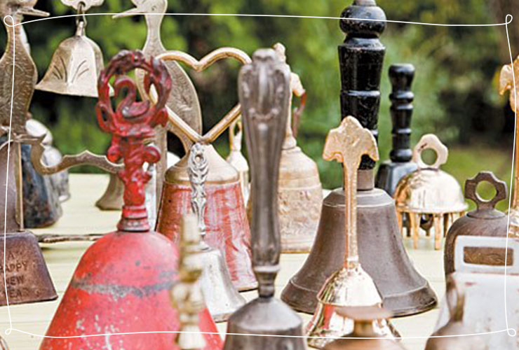 Antique bells sit on a table 