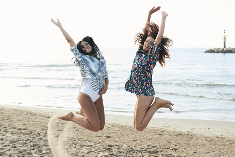 Friends jumping on beach