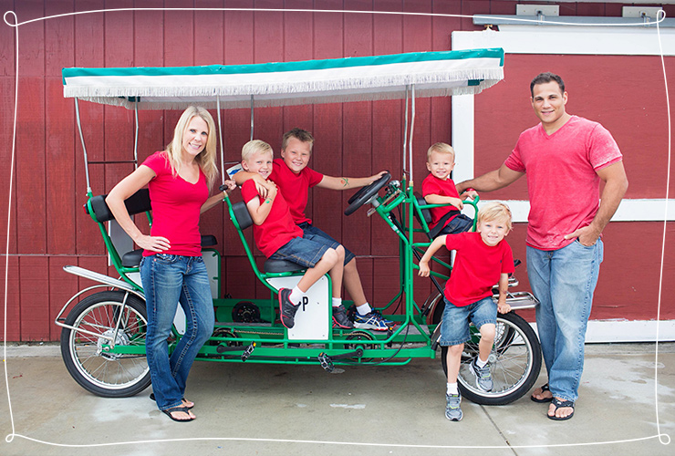 Family in matching red shirts with green bikes