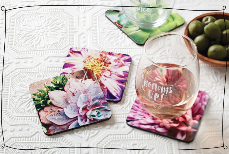 Wine glasses with quotes sit on photo coasters