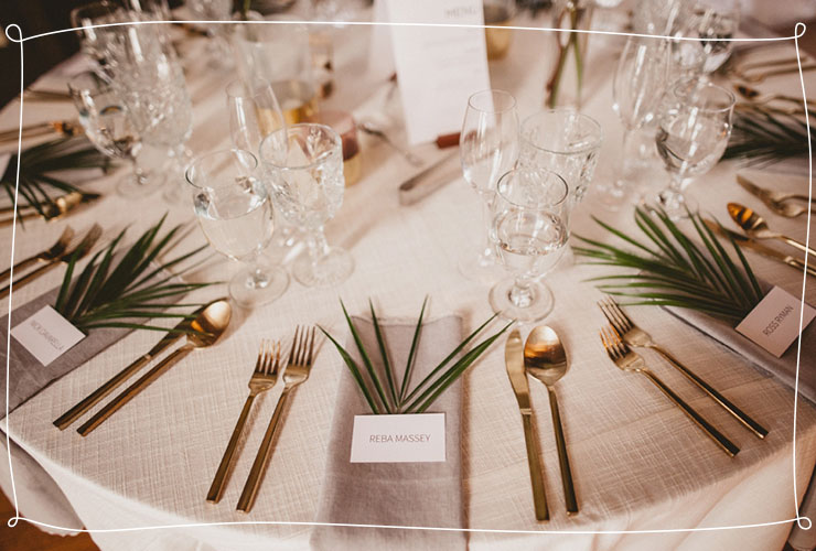 palm leaves sit on table setting 