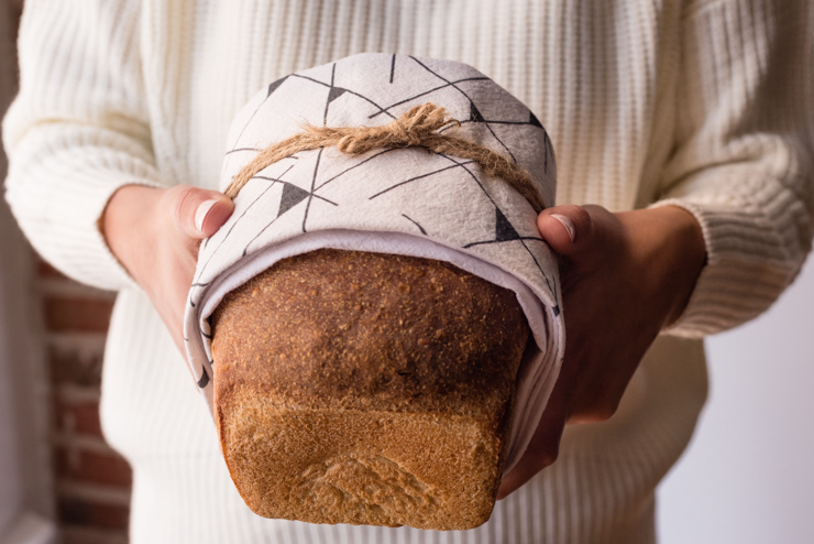 Loaf of bread wrapped in tea towel
