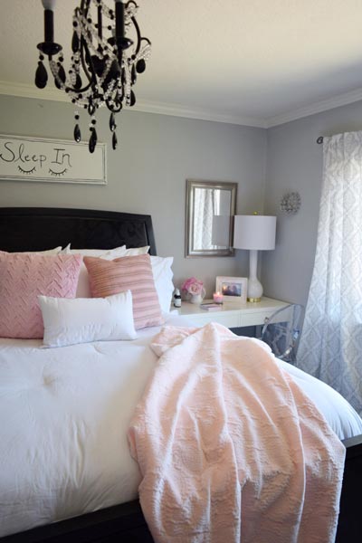 white bedding with colorful pillows